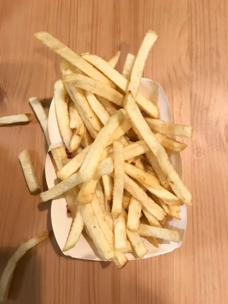 in n out french fries from up above on a wooden table