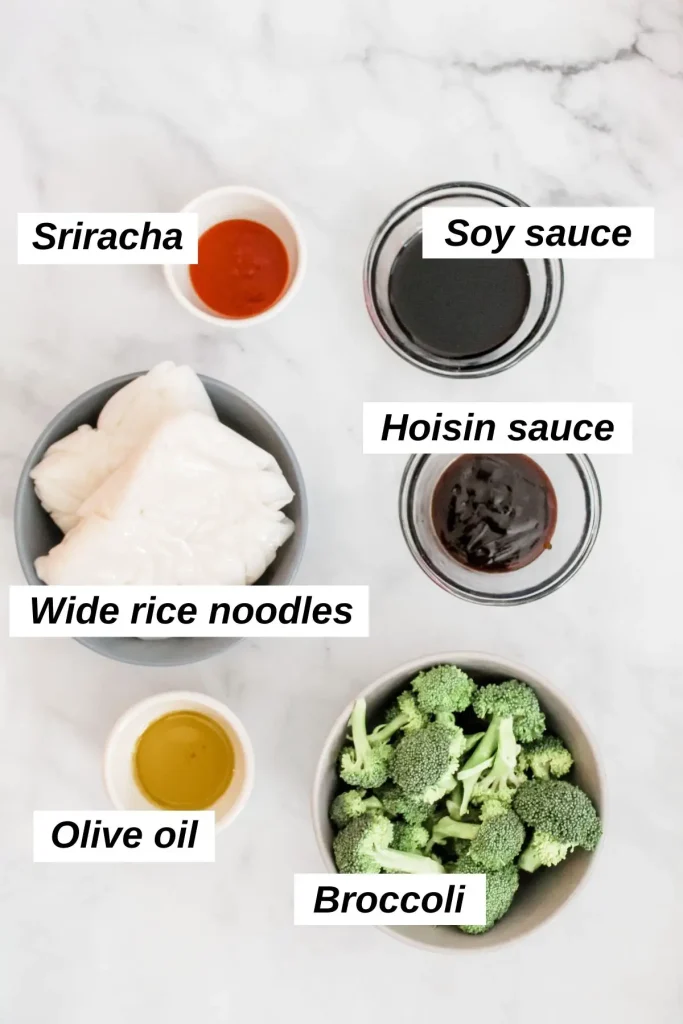 individual ingredients for vegan pad see ew, including broccoli, wide rice noodles, oil, and sauces