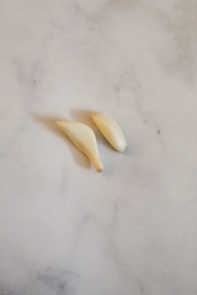 two cloves of garlic that have been peeled