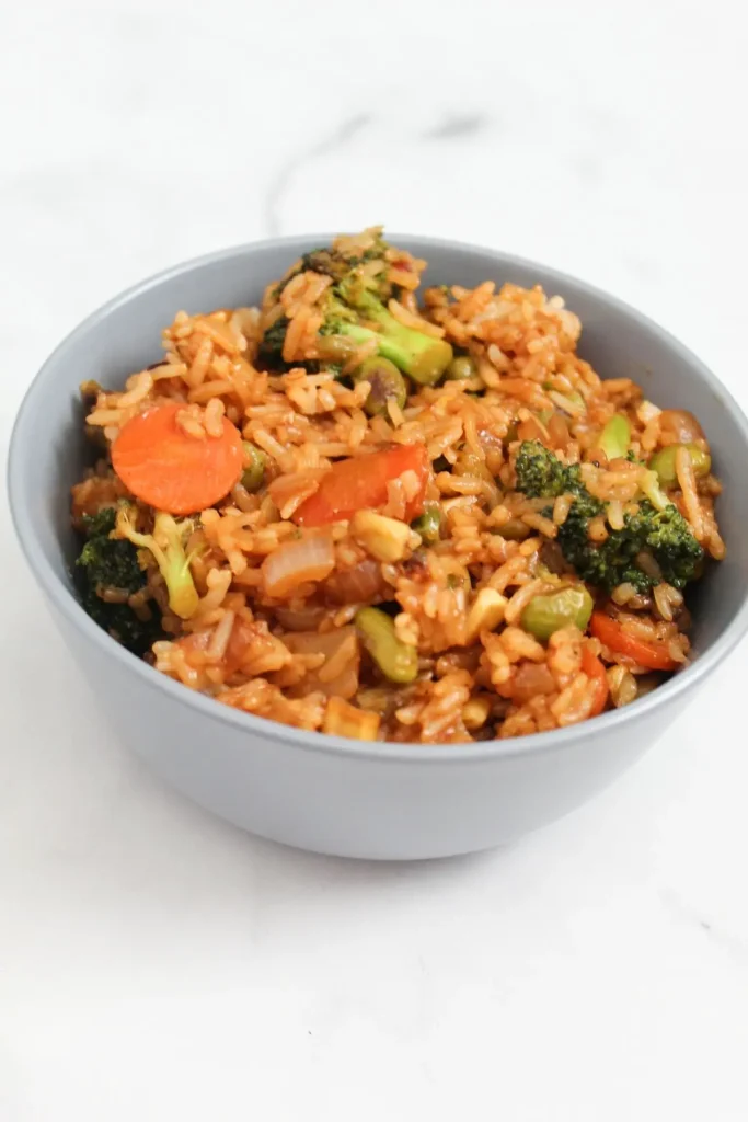 vegetable fried rice finished view on a blue bowl marble surface
