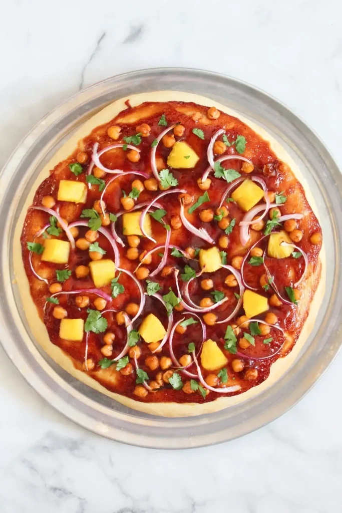 bbq pizza fresh out of the oven with golden brown crust and topped with freshly chopped cilantro