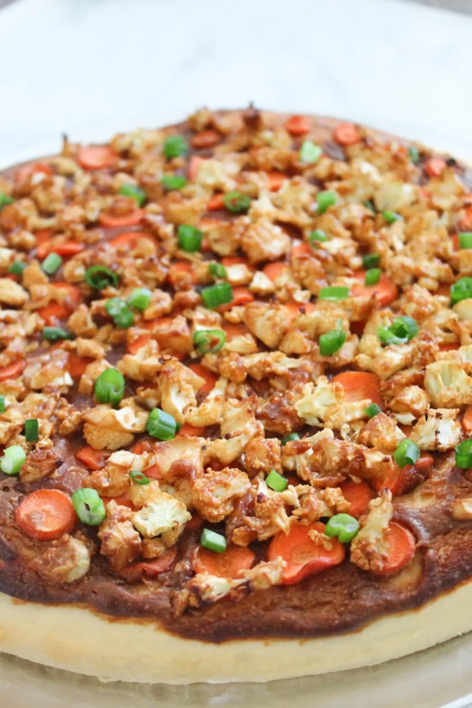 close up view of finished thai pizza topped with fresh green onions