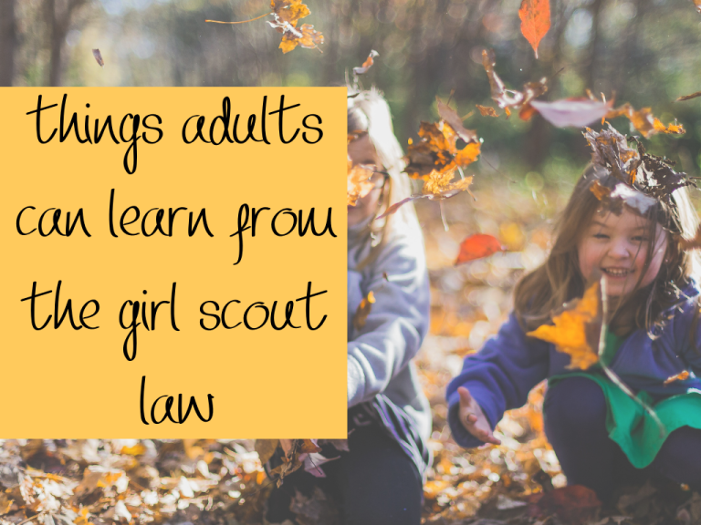 girls throwing leaves into the air