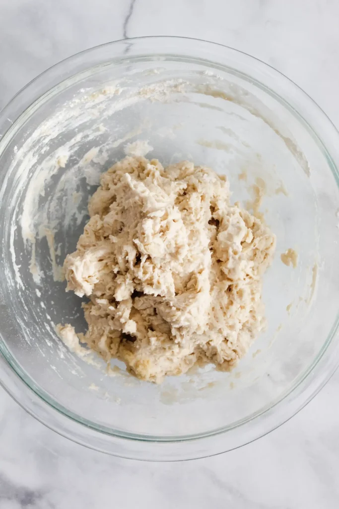 mixing salt, olive oil, and flour to the proofing yeast
