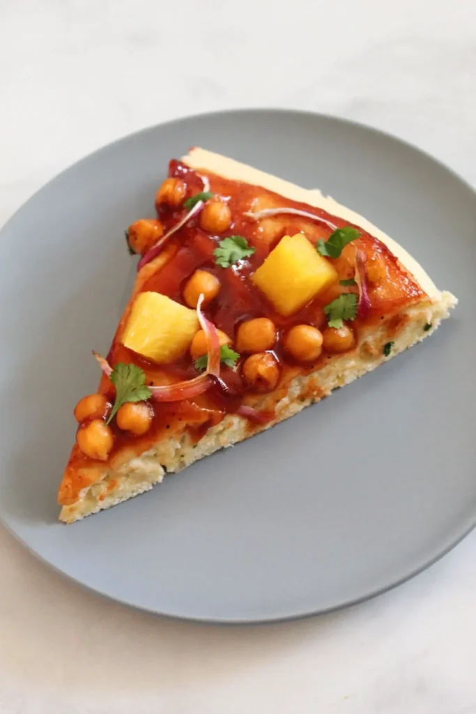 one slice of vegan barbecue pizza on blue plate