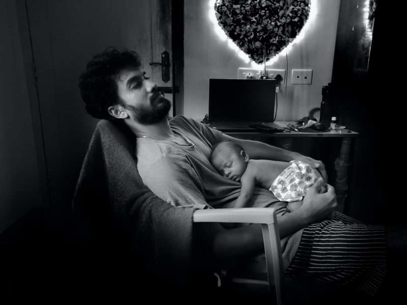 father holding new baby