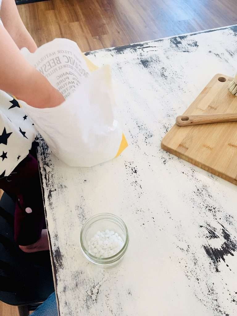 Toddler measuring beeswax